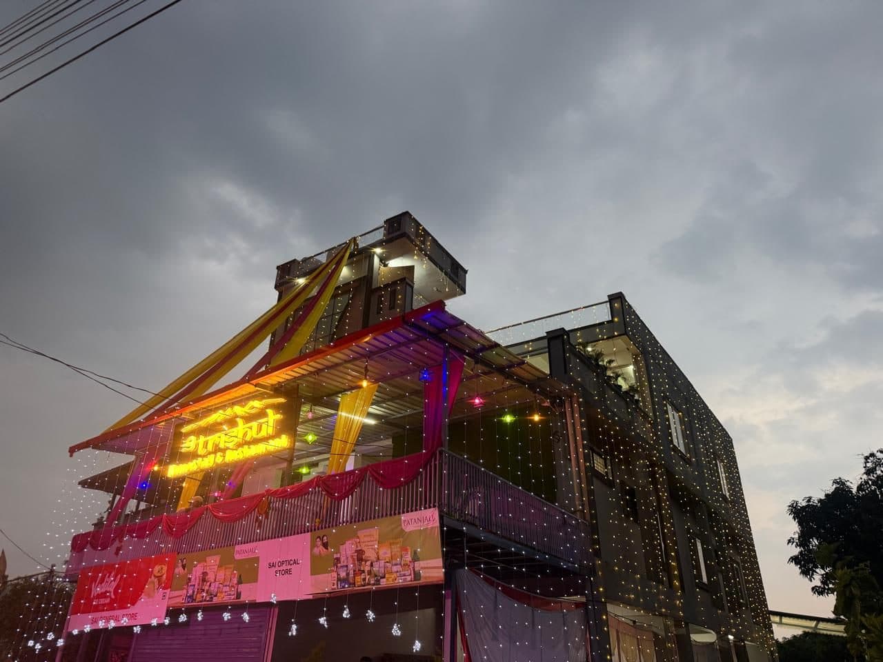 Trishul Homestay & Restaurant lit up at dusk, seen from the street
